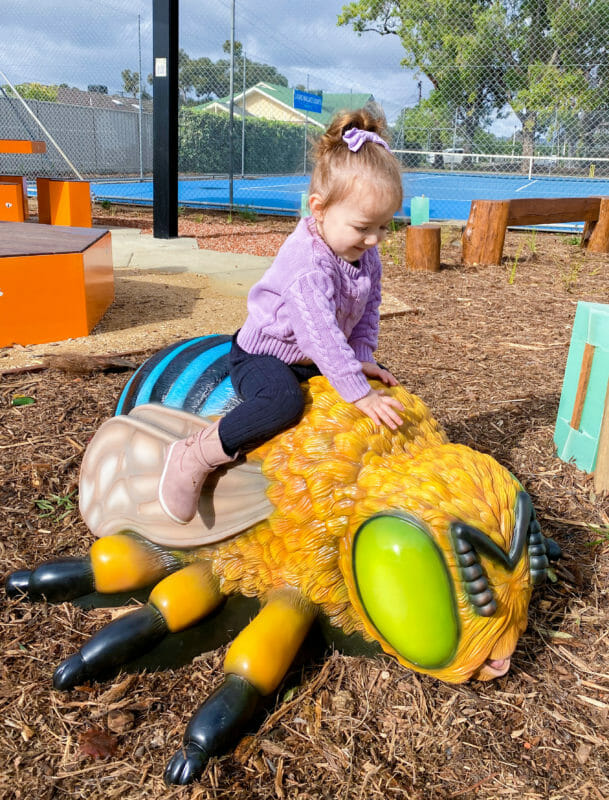 Girl on Bee Sculpture